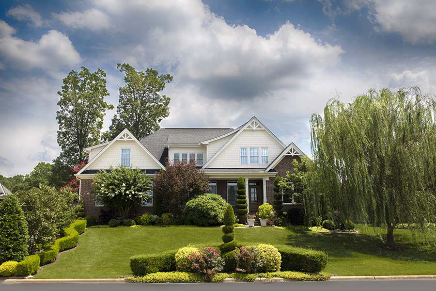 Lockhart houses for sale are shown with trees in their front yards.