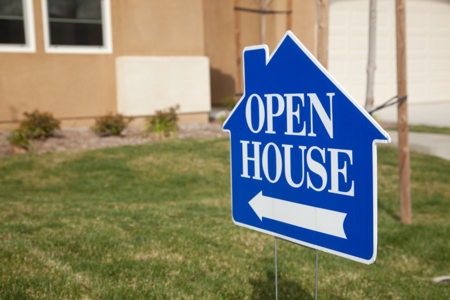 Blue sign pointing to open house