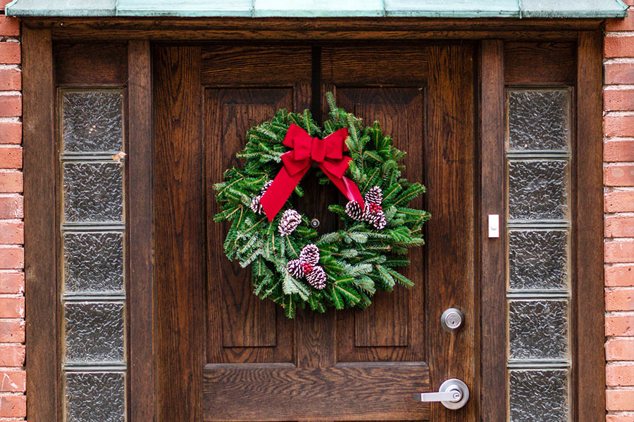 Christmas wreath on front door of a house for sale by our Lockhart Realtors