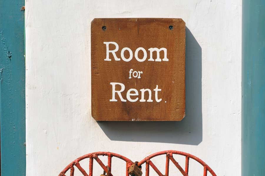 Sign reading "Room for Rent" on a duplex in Lockhart TX, from our real estate team