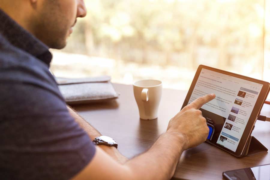 Man browsing online for commercial real estate in Lockhart and houses for sale