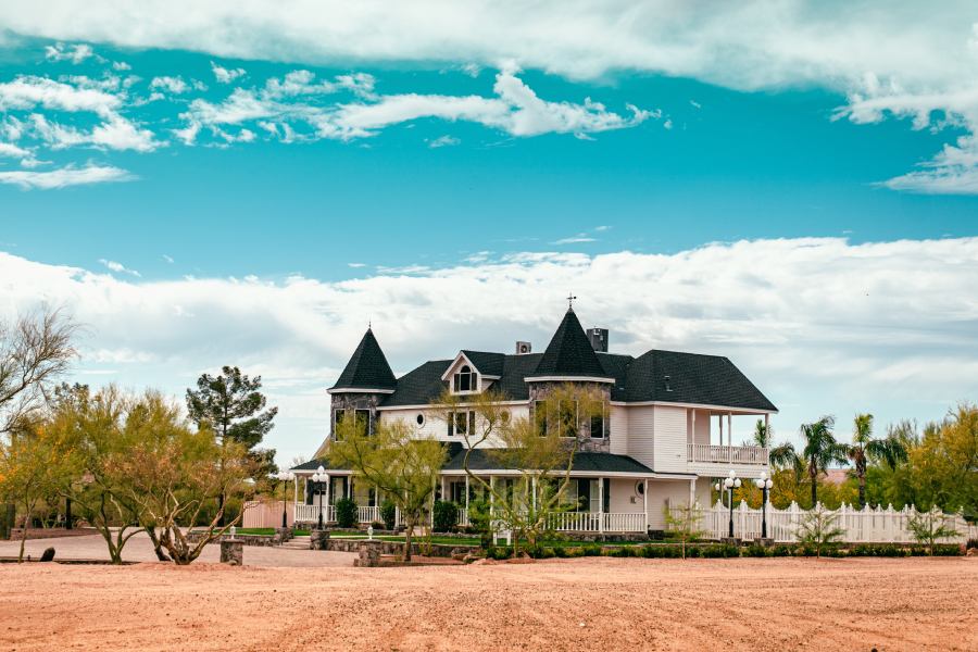 victorian style home painted white with majestic roof