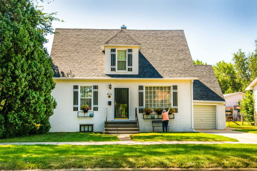 Woman in front of home for sale in Lockhart TX