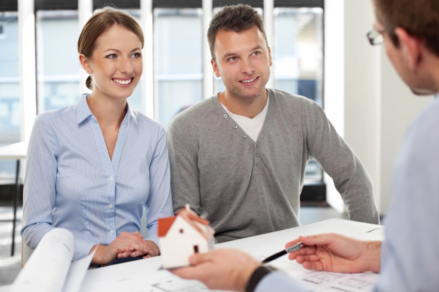 A couple discussing Lockhart leasing and purchasing options at a real estate agent's office