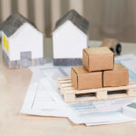 A Luling realtor desk with house models, documents, and calculator.