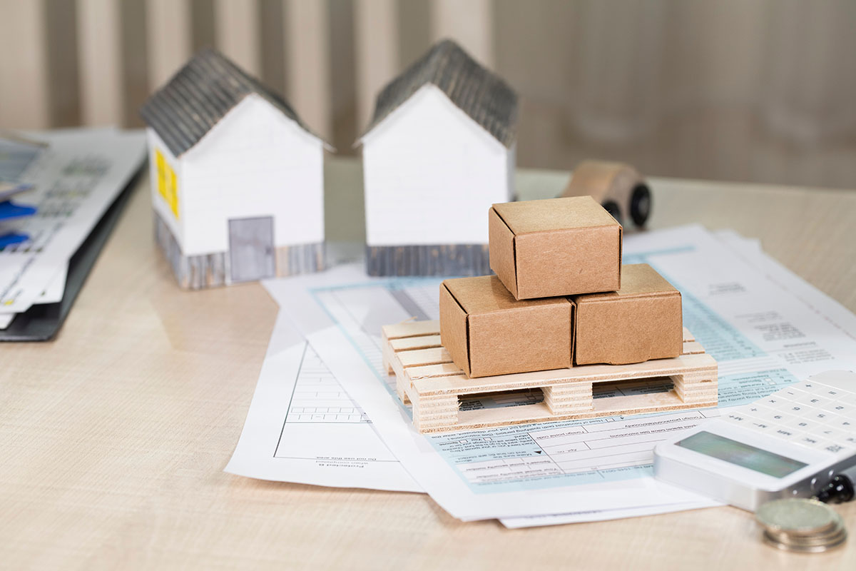 A Luling realtor desk with house models, documents, and calculator.